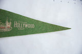 Pointed tip of vintage green felt Hollywood banner showing textile texture and small pinhole.