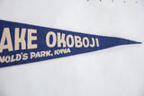 Vintage Lake Okoboji felt pennant detailing cream 'OKOBOJI' lettering and blue texture.