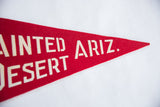 Vintage red felt pennant with white 'ARIZ.' lettering on textured surface.