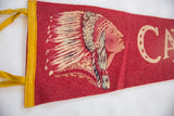 Close-up of the Native American chief graphic on the textured red felt of a vintage pennant.