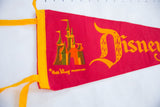 Vintage Disneyland felt pennant's yellow binding, ties, and colorful castle graphic.