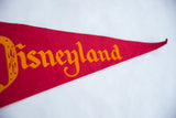 Orange 'Disneyland' script on vintage red felt pennant's pointed end.