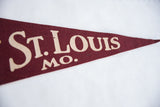 Detail of vintage maroon felt St. Louis pennant, cream 'ST. LOUIS MO.' text.