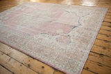 Distressed pink and ivory abrashed field with navy floral motifs and meandering border details.