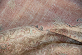 Distressed vintage Sparta rug detail, showing low pile, exposed foundation, and faded floral patterns.