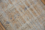 Worn pile and visible foundation of vintage Oushak rug with subtle floral gul in neutral tones.