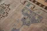 Distressed vintage Oushak runner in faded royal blue, blush, and sand geometric floral design.
