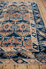 Vintage Oushak runner's secured fringe and distressed indigo hook and latch border.