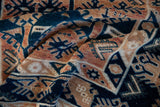 Distressed vintage Oushak rug with indigo blue, terracotta gul and hook-latch motifs.