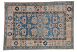 Vintage distressed Oushak rug featuring a sky blue field with ivory floral palmettes.