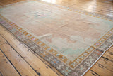 Vintage Kars carpet from an angle, showing the distressed low pile and abrashed field.