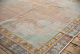 Angled view of the distressed texture and low pile on a Kars carpet in dusty beige and blush.