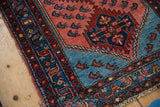 Vintage Lilihan rug detail with brilliant aqua blue spandrel, serrated edge, and red shrimp motifs.