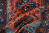 Folded vintage Lilihan rug displaying aqua blue spandrel and Caspian sea shrimp motif.