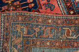 Intact side selvage of vintage Lilihan rug runner with geometric patterns in blue, red, and ivory.
