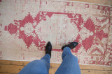 Vintage distressed Oushak runner with mostly even wear, abrashed texture in pale red and ivory.