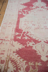 Distressed vintage Oushak runner with worn pile, pale cochineal red, and ivory abrashed field.