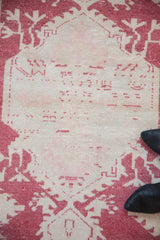 Distressed Vintage Oushak rug runner: visible wear, pale cochineal red, ivory, and pink abrashed field.