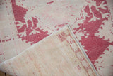 Distressed vintage Oushak rug runner showing worn pile, cochineal red pattern, and reverse foundation.