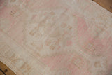 Distressed vintage Oushak runner pile, pale pink and ivory worn texture.
