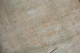 Reverse of Oushak rug showing hand-knotted foundation and subtle painted numbers.