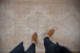 Low-pile, knotted texture of a distressed Turkish Oushak runner in soft beige and sand.