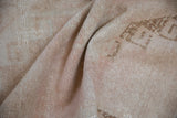Soft drape of a vintage Oushak runner showing its mostly even, hand-knotted low pile.