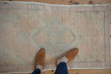 Overhead view showing the scale and soft, worn texture of a vintage Oushak rug.