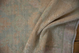 Soft, nubby texture of a distressed vintage Oushak rug with a low pile worn to the knots.