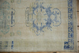 Distressed Oushak runner's worn pile, abrash, pale blue motifs, and geometric border.