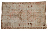 Distressed Turkish Melas rug, faded coffee brown medallion, soft blush, and ivory plant motifs.