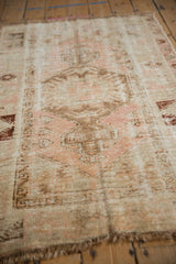 Textured distressed Melas rug with blush, ivory, coffee brown medallion and foundation wear.