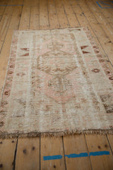 Frayed fringe and worn foundation texture of the blush and ivory distressed Melas rug.