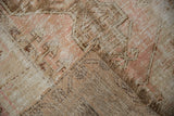Close-up of distressed vintage Melas rug pile, exposed knot heads, coffee brown and blush.