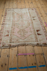 Tattered end of the distressed vintage Melas rug, secured with blanket stitch overcast.