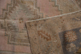 Distressed vintage Melas rug showing wear to knot heads and tightly woven hand-knotted foundation.