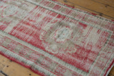 Distressed vintage Oushak runner texture with cherry red, beige abrashes, and foundation wear.