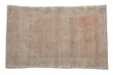 Vintage distressed Oushak rug with a faded prayer design in soothing melon and ivory tones.