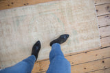 Distressed vintage Oushak runner, showing even wear, subtle patterns, and soft neutral tones.
