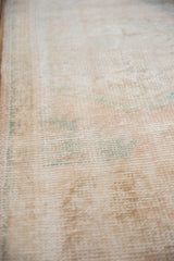 Distressed Oushak runner's mostly even wear, exposed foundation, with pale seafoam hints.