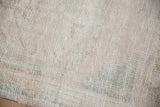 Ivory and beige distressed Oushak rug pile with subtle seafoam green.