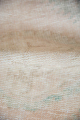 Distressed Oushak rug pile: mostly even wear to knot heads, ivory, beige, seafoam tones.