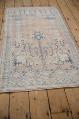 Distressed vintage Oushak rug fringe and textured border in pale beige and blue.