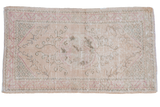 Distressed vintage Oushak rug featuring a roundel medallion, floral motifs, ivory, pale rose, beige, seafoam.