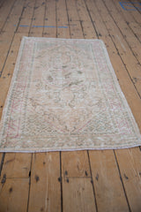 Distressed Turkish Oushak corner spandrel with pale dusty rose and beige lattice wear.