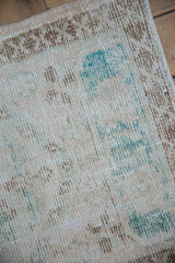 Distressed Oushak runner texture, ivory and dusty turquoise with faded cross-hatch elements.