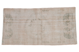 Distressed Oushak runner, ivory field with faded pale green medallion motifs.