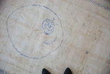 Distressed vintage Oushak rug detail showing ivory field, cobalt blue roundel, and foundation wear.