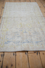 Distressed vintage Oushak runner showing worn pile, exposed foundation, and subtle ivory, blue, gold.