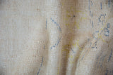Hand-knotted backing of a vintage Oushak rug, showing tight weave and pale blue and gold threads.